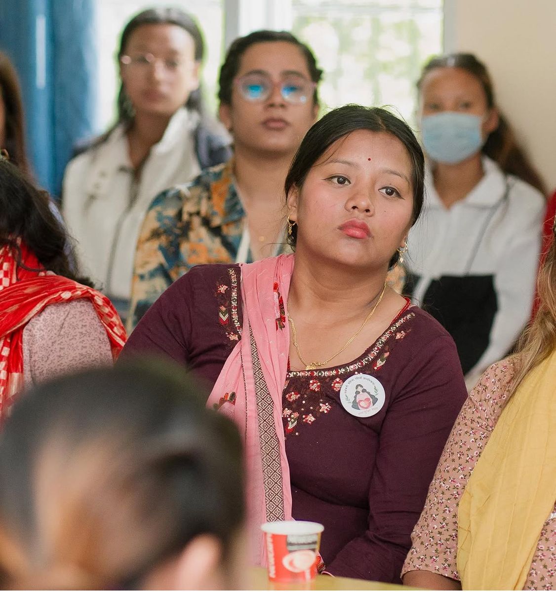 A woman wearing the maternal identification badge